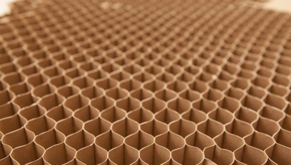 Honeycomb cardboard cells. Geometric background with copy space. Recyclable craft paper.